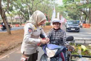 SatPOL PP memberikan bendera merah putih kepada warga.